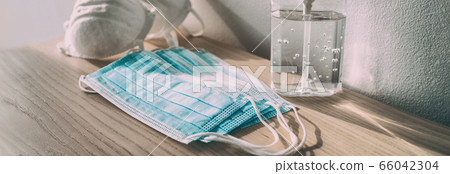 Coronavirus prevention medical surgical masks and hand sanitizer gel bottle dispenser for Covid-19 corona virus protection. Panoramic of PPE 66042304