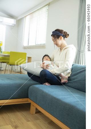 Mom holding a baby 66043493