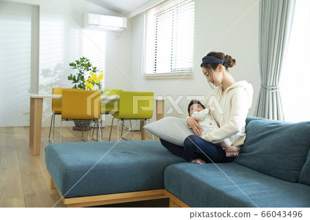 Mom holding a baby Mom holding a baby 66043496