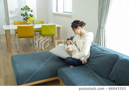 Mom holding a baby 66043503
