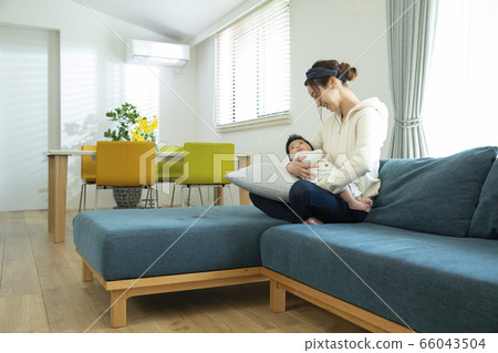 Mom holding a baby 66043504