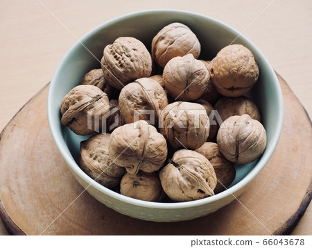 Organic walnuts in a ceramic bowl Organic walnuts in a ceramic bowl 66043678