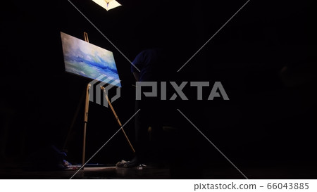 Artist copyist paint seascape with ship in ocean. Craftsman decorator draw as boat sail on blue sea. Black background. Wide angle shot. 66043885