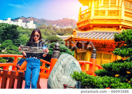 Young female tourist with map looking for a way to 66043886