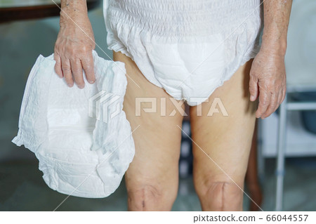 Asian senior or elderly old lady woman patient wearing incontinence diaper in nursing hospital  66044557