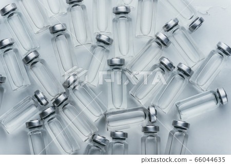 Glass medical ampoule vial for injection. Medicine is dry white drug penicillin powder or liquid with of aqueous solution in ampulla. Close up. Glass medical ampoule vial for injection. Medicine is dry white drug penicillin powder or liquid with of aqueous solution in ampulla. Close up. 66044635