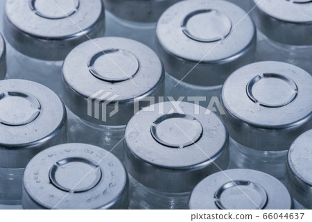 Glass medical ampoule vial for injection. Medicine is dry white drug penicillin powder or liquid with of aqueous solution in ampulla. Close up. 66044637