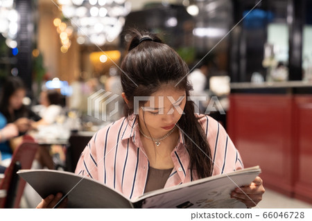Asian Beautiful woman ordering from menu. Asian Beautiful woman ordering from menu. 66046728