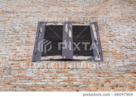 Old window closed on brick wall background. Old window closed on brick wall background. 66047909