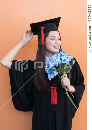 Asian graduate woman in cap gown on isolated Asian graduate woman in cap gown on isolated 66048212