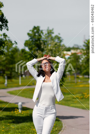 Young carefree female in glasses and trendy outfit 66048462