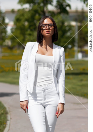 Young carefree female in glasses and trendy outfit 66048466