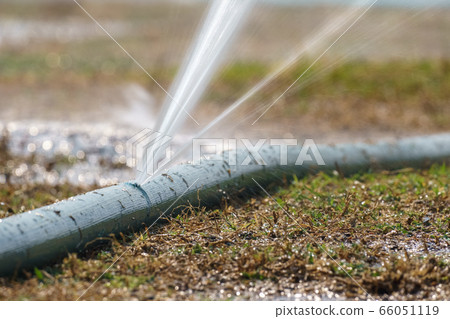 water leaking from hole in a agriculture hose. 66051119
