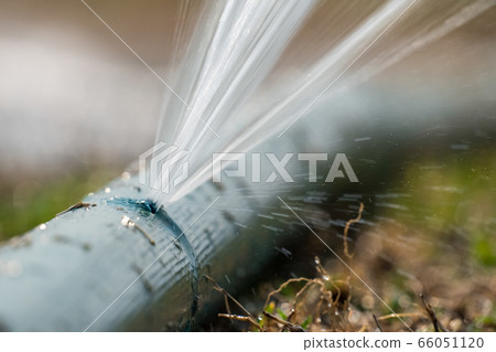 water leaking from hole in a agriculture hose. 66051120