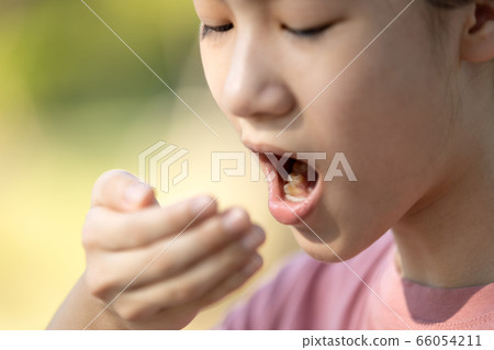 Child girl checking breath with her hand,woman doing a bad breath test after have breakfast,foul mouth from inside the tongue,teeth and gums,oral bacteria problems,halitosis,health care,dental concept 66054211