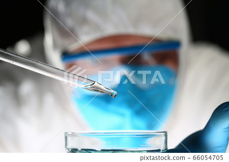 Focused photo on pipette that dropping liquid 66054705