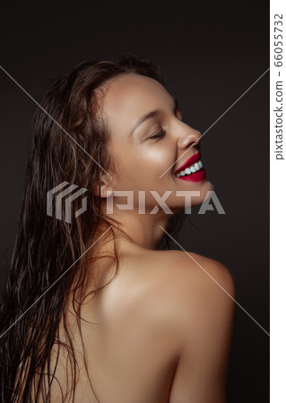 Portrait of beautiful stylish woman isolated on dark studio background Portrait of beautiful stylish woman isolated on dark studio background 66055732