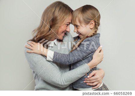 Happy family. Mother and daughter hugging. Happy family. Mother and daughter hugging. 66058269