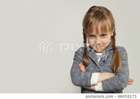 Funny little child girl with crossed arms on white Funny little child girl with crossed arms on white 66058273