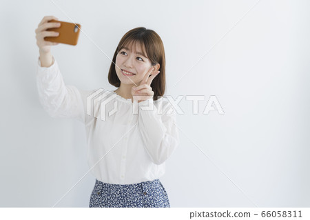 Woman using a smartphone 66058311