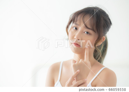 Beautiful portrait young asian woman with acne problem in the bedroom Beautiful portrait young asian woman with acne problem in the bedroom 66059338