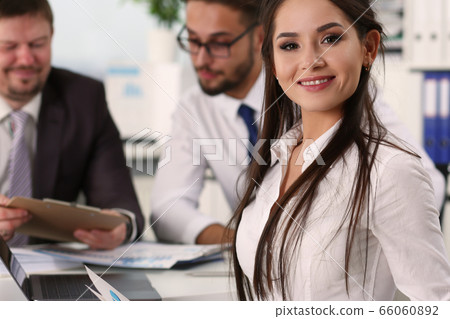 Positive delighted young woman looking at camera 66060892