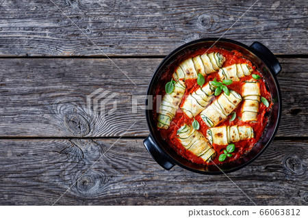 Zucchini rollatini baked in the passata, top view 66063812