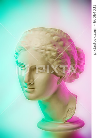 Statue of Venus de Milo. Creative concept colorful neon image with ancient greek sculpture Venus or Aphrodite head. Webpunk, vaporwave and surreal art style. Pink and green duotone effects. 66064033