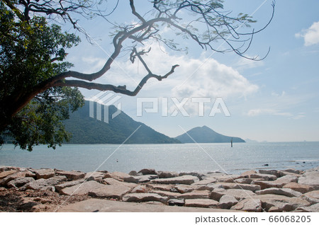 Sunny beautiful beach with rock shores and big sea 66068205