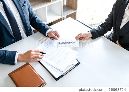 Image of business woman hand sending a resignation Image of business woman hand sending a resignation 66068734