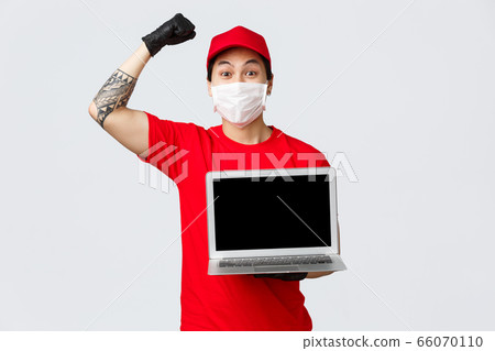 Cheerful happy asian delivery guy deliver parcels during covid 19 pandemic, safe shopping online. Courier holding laptop and showing advertisement on screen, chanting, raise hand in celebration Cheerful happy asian delivery guy deliver parcels during covid 19 pandemic, safe shopping online. Courier holding laptop and showing advertisement on screen, chanting, raise hand in celebration 66070110