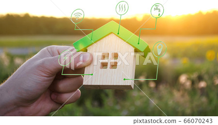 Miniature house and symbols of public utilities. Choosing a home to buy, assessing the cost and condition of the building. Location in the city. Repair and renovation, maintenance services. Miniature house and symbols of public utilities. Choosing a home to buy, assessing the cost and condition of the building. Location in the city. Repair and renovation, maintenance services. 66070243