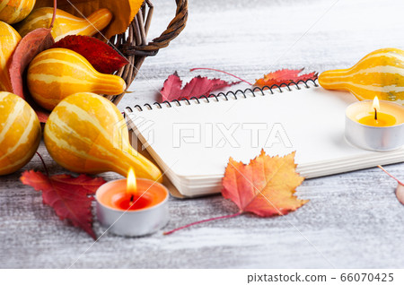 Small decorative pumpkins with lit candles Small decorative pumpkins with lit candles 66070425