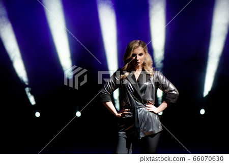 Young woman with colorful lights on concert on the 66070630