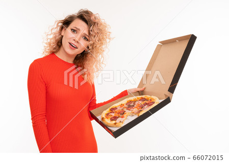 european curly blond girl in a red dress holds a box of pizza on a white studio background european curly blond girl in a red dress holds a box of pizza on a white studio background 66072015