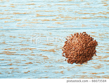 flax seeds on a blue wooden background, top view. flax seeds on a blue wooden background, top view. 66073584