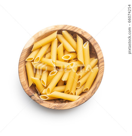 Uncooked penne pasta in bowl. Dried italian pasta Uncooked penne pasta in bowl. Dried italian pasta 66074254