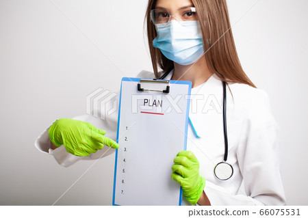 Doctor in white coat holds letter with a plan of action 66075531