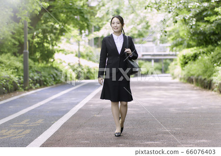 Young woman business outdoors smiling Young woman business outdoors smiling 66076403