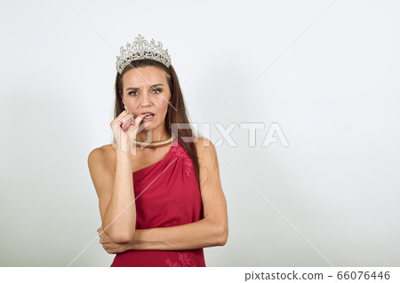 Indecisive Female Holds A Finger Near Her Lips And Hesitates. Human Doubt 66076446