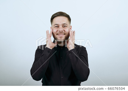 Happy Male Smiles, Touches Fingers To His Face. The Concept Of Tenderness. Happy Male Smiles, Touches Fingers To His Face. The Concept Of Tenderness. 66076504