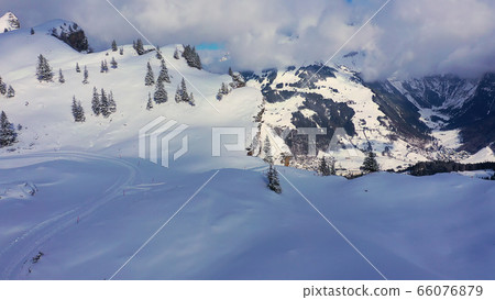 Fantastically beautiful snow landscape in the mountains - aerial flight footage Fantastically beautiful snow landscape in the mountains - aerial flight footage 66076879