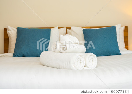 White clean bath towel on bed decoration interior White clean bath towel on bed decoration interior 66077584
