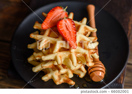 Delicious fresh baked belgian waffles with berries Delicious fresh baked belgian waffles with berries 66082001