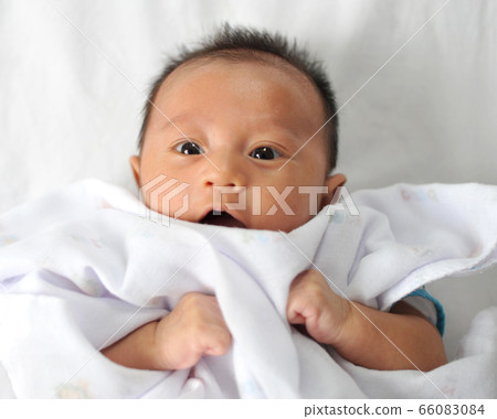 Adorable baby boy in bedroom. Newborn child Adorable baby boy in bedroom. Newborn child 66083084