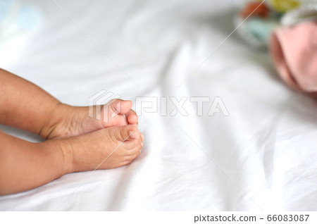 Feet of a newborn baby in the hands of parents. 66083087