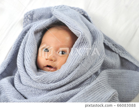 Cute happy baby new born lying on a blue knitted Cute happy baby new born lying on a blue knitted 66083088