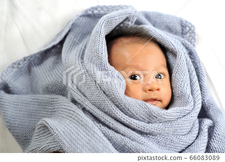 Cute happy baby new born lying on a blue knitted Cute happy baby new born lying on a blue knitted 66083089