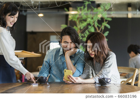 Male and female chatting at a cafe 66083196