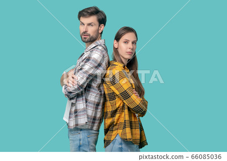 Girl and man standing with their backs clasped hands 66085036
